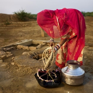 Indian woman getting water from the well. Rajasthan, Thar desert