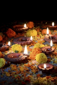 Clay diya lamps lit with Lord Ganesha during diwali celebration